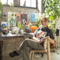Artist Hayley Wall from Pain Unmasked sits in her studio.